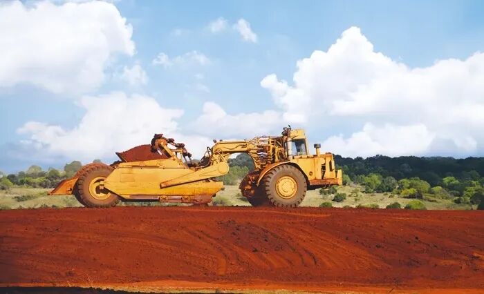 Scraper vehicle in construction environment
