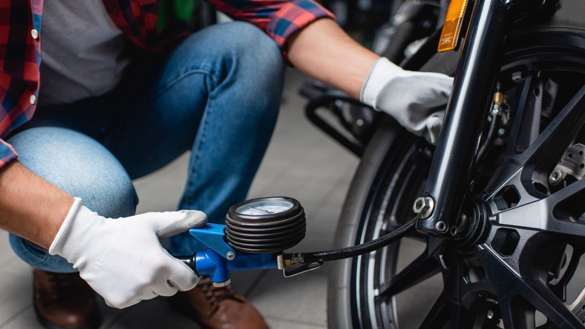 A man checking tyre pressure