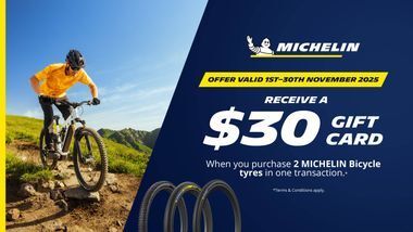 Bicycle fitted with Michelin tyres on the left handside, and $30 giftcard promotion on the right