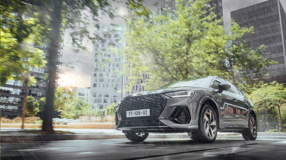 A car cruises along a city street, providing a calm and comfortable ride for the urban zen driver.