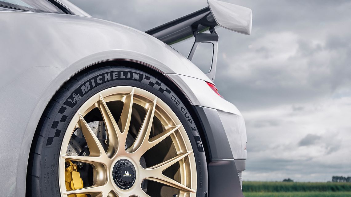 Sporty driving promotional image showcasing high-performance tires.