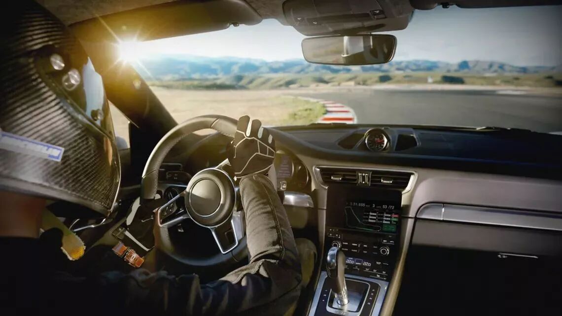 Driver navigating a sleek performance car on a winding road, representing precision driving for a Weekend Racer