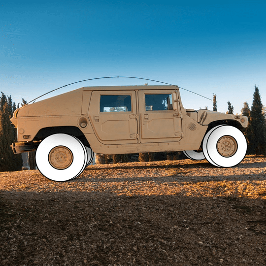 Military vehicle equipped with all-terrain tires for rugged environments.