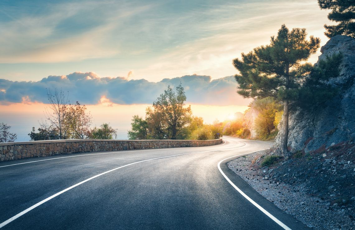 Paesaggio autunnale, strada con tornanti su lago e montagne