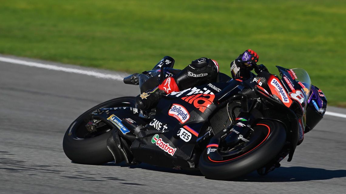 MotoGP rider leaning sharply on an Aprilia racing motorcycle with MICHELIN tyres during the Valencia official test.