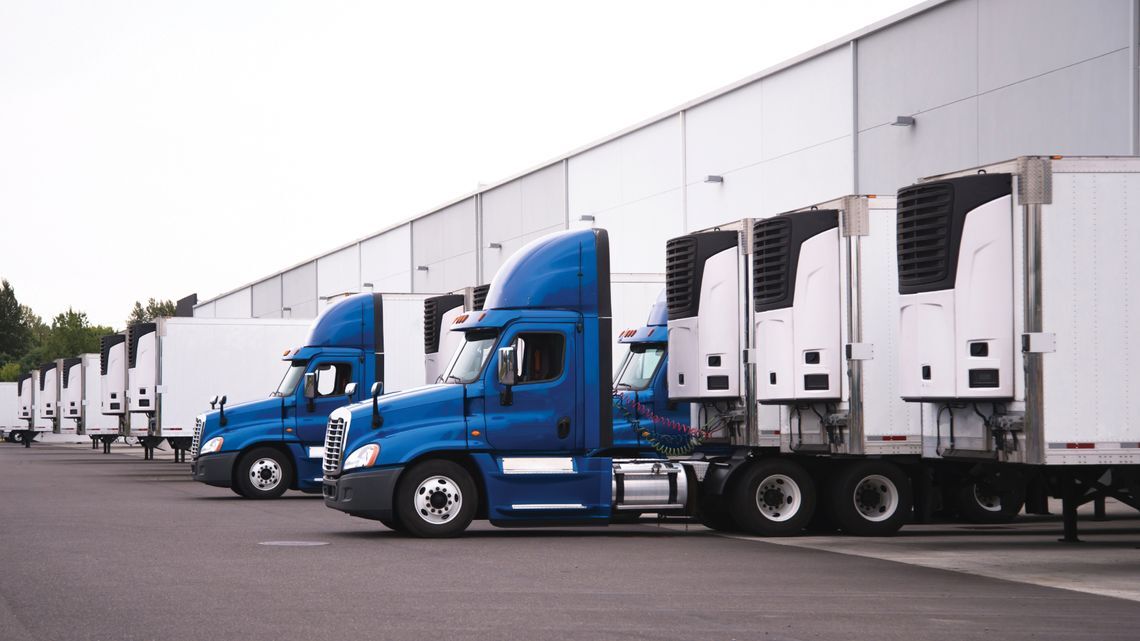 Image of semi-trucks docked at a warehouse